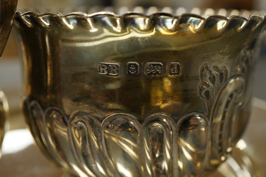 A Victorian silver side plate or stand, by John Edward Bingham (Walker & Hall), Sheffield, 1885, diameter 17.9cm, together with an early 20th century silver cream jug and sugar bowl by Barker Brothers and a Victorian pro